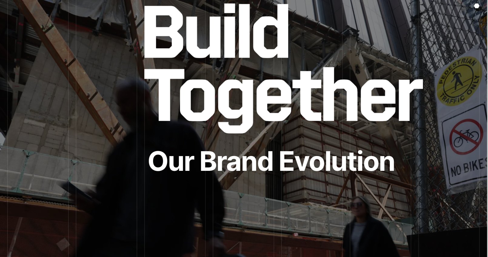 Build Together brand evolution cover: the words 'Build Together — Our Brand Evolution' set over a darkened photograph of a city construction site.