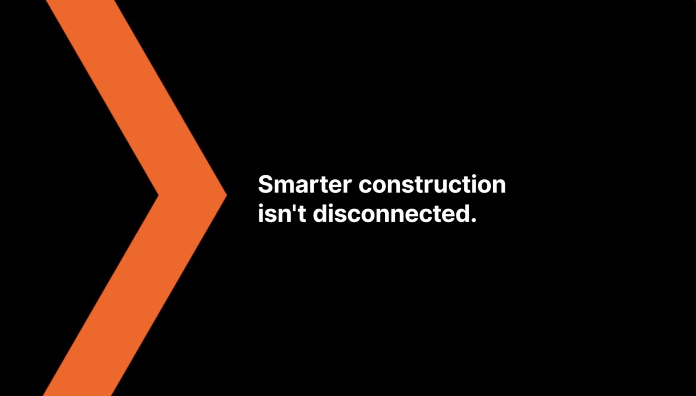 Frame from the Procore UKI film: an orange chevron beside the line 'Smarter construction isn't disconnected.'
